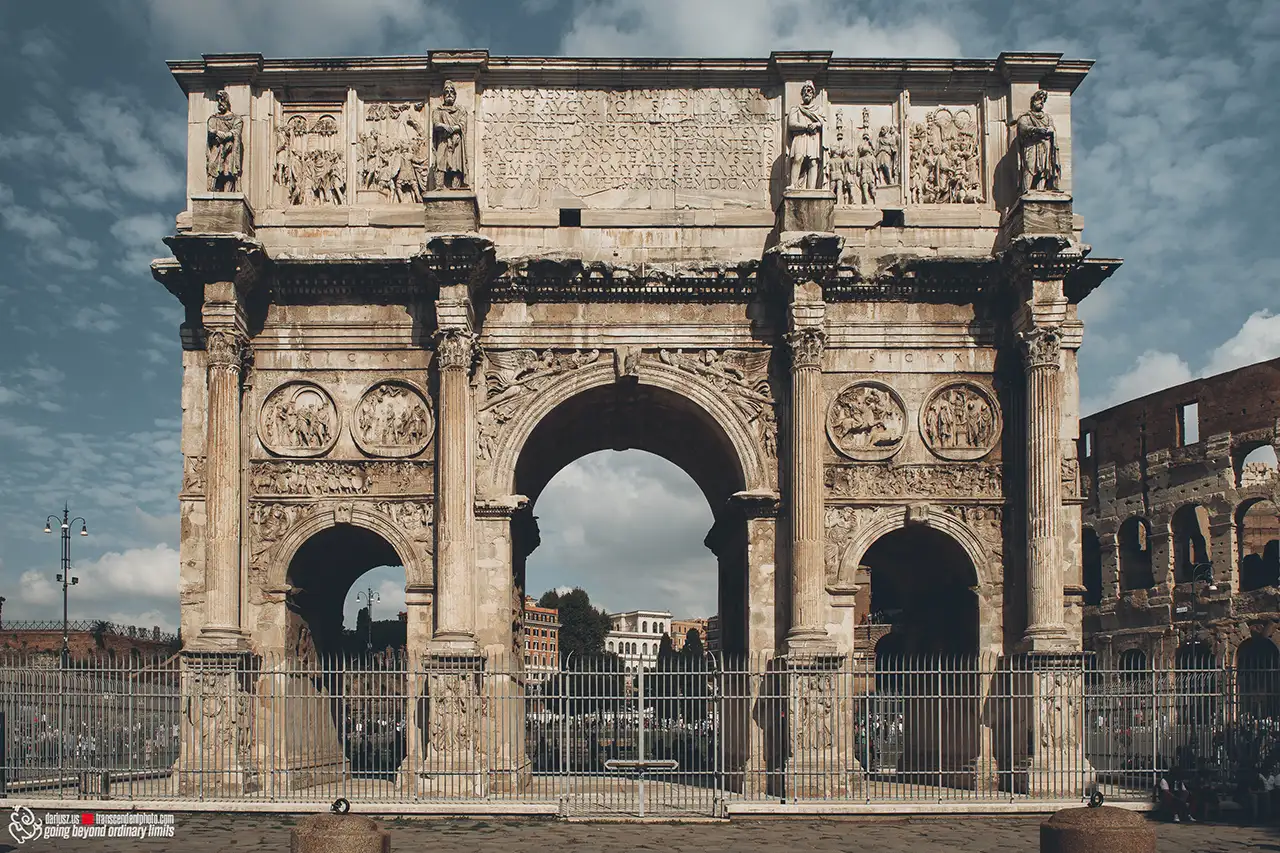 Arch of Constantine in Rome with Colosseum visible behind.