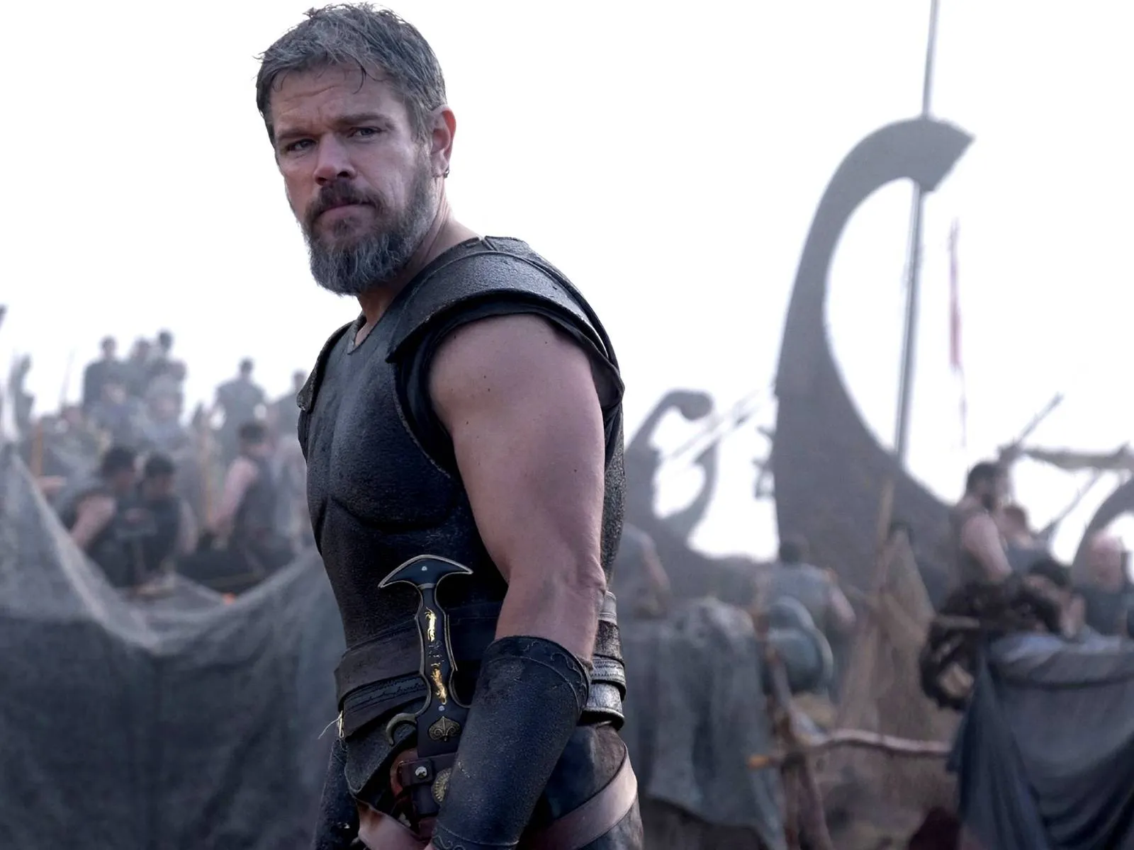 Matt Damon as a bearded warrior in armor with a dagger.