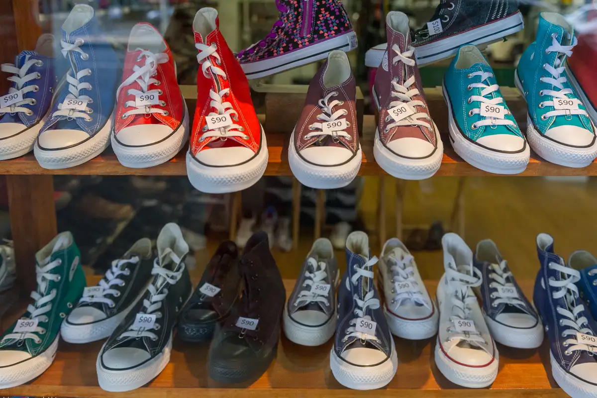 Colorful high-top sneakers with price tags displayed in a store.
