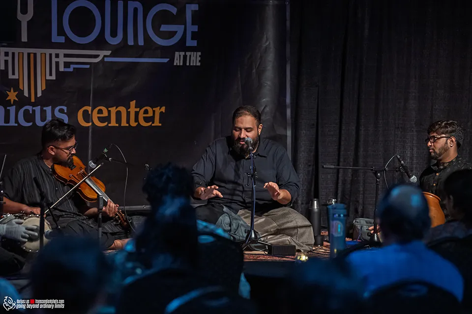 Live musical performance with violin, singer, and percussionists for an audience.
