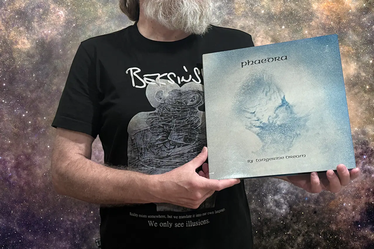 Dariusz holding Tangerine Dream's 'Phaedra' vinyl record against space background.